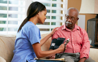 caregiver getting the patients blood pressure